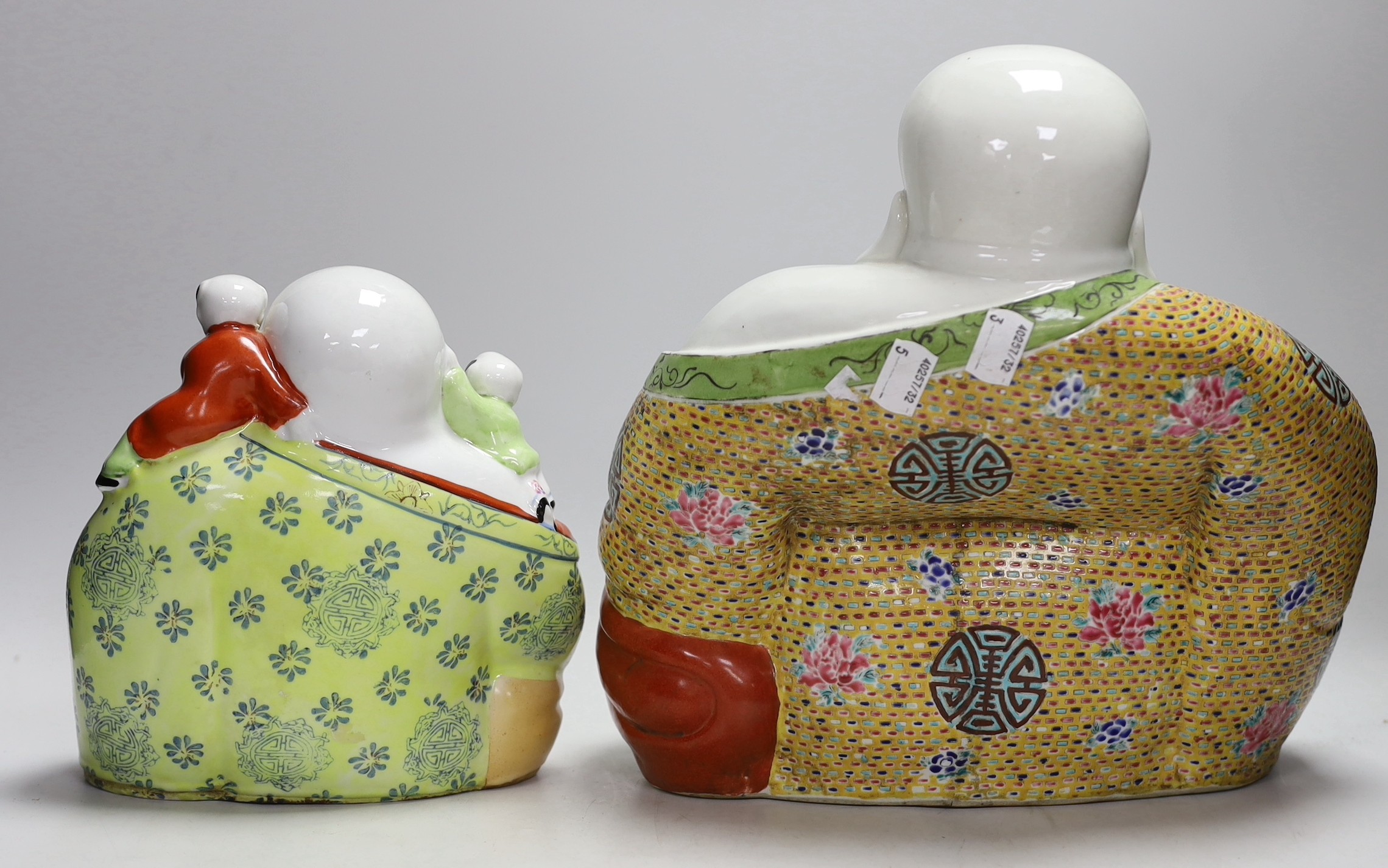 Two Chinese porcelain enamelled Budai figures, tallest 29cms high